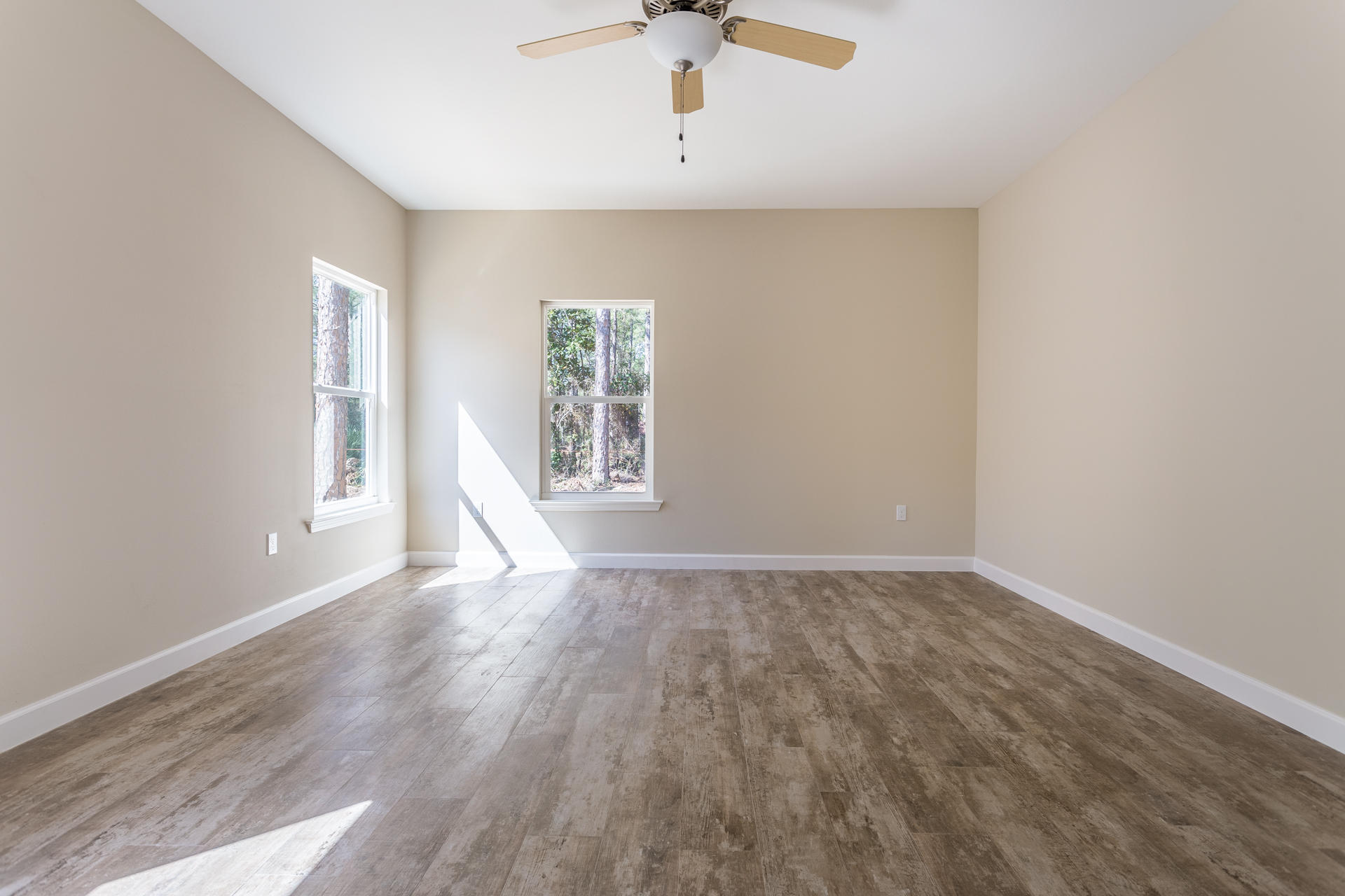 343 Indian Woman Road Santa Rosa Beach, FL 32459 - Photo 12 of 21 wooden floor in an empty room with a window