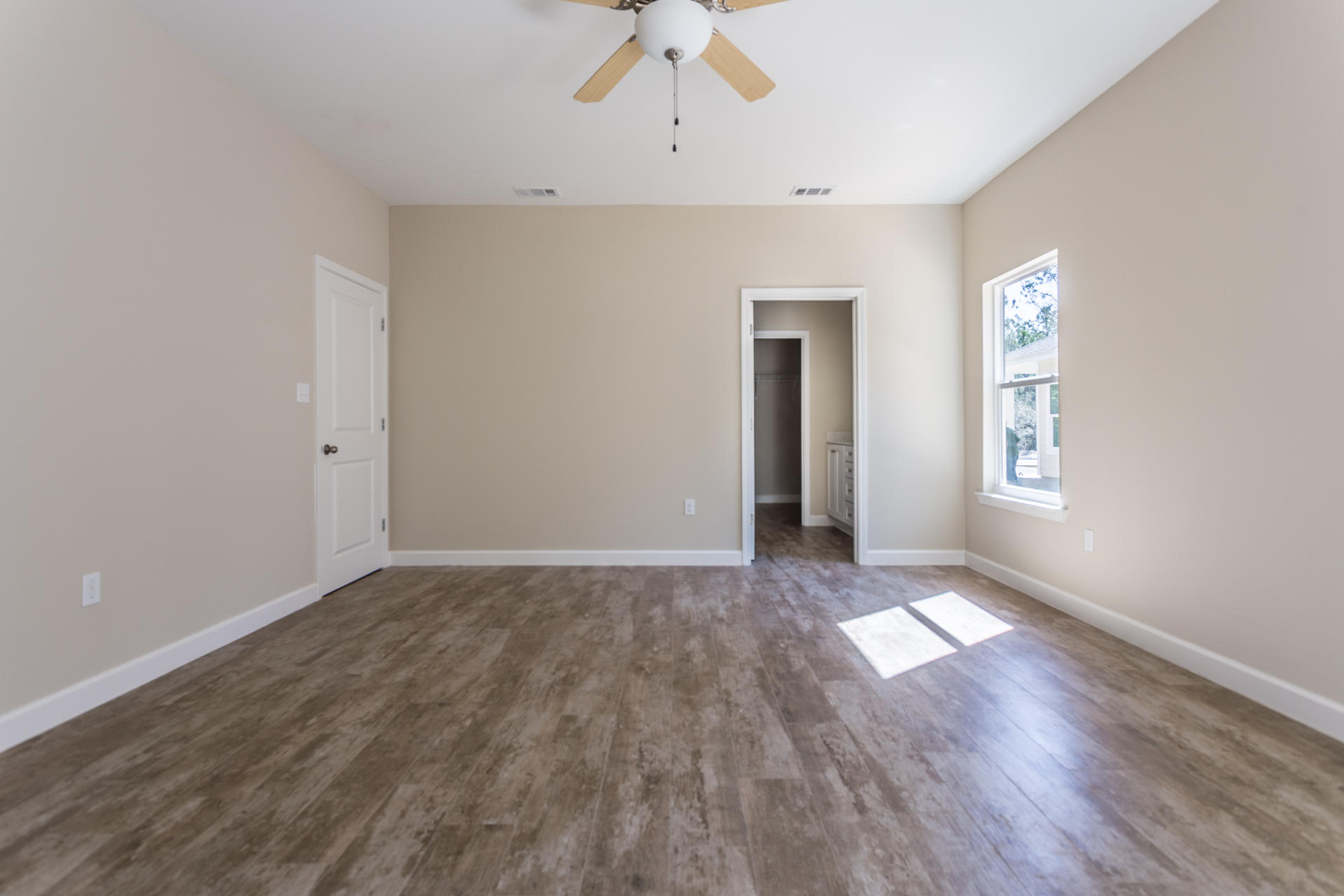 343 Indian Woman Road Santa Rosa Beach, FL 32459 - Photo 13 of 21 an empty room with wooden floor chandelier and windows