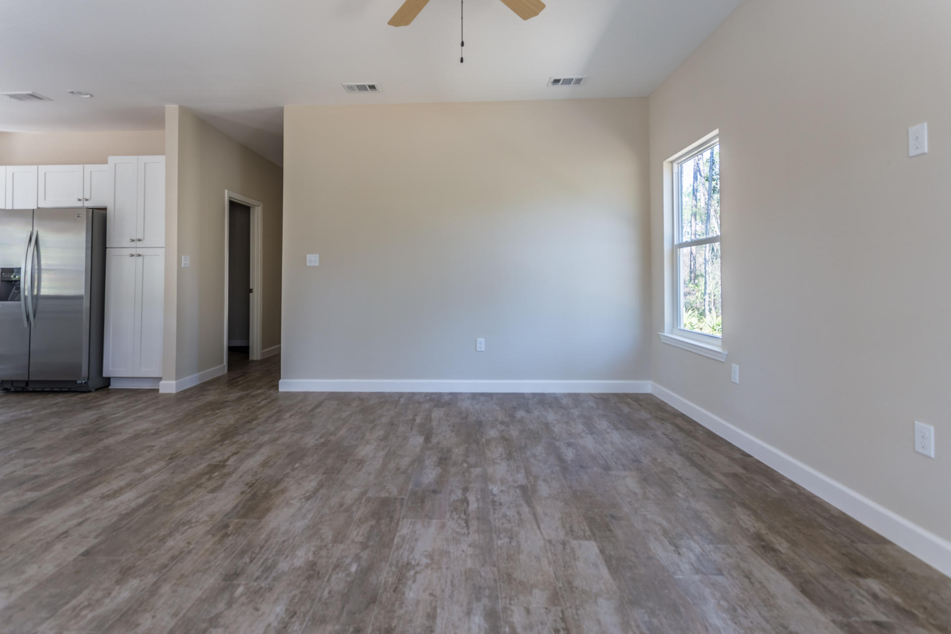343 Indian Woman Road Santa Rosa Beach, FL 32459 - Photo 3 of 21 an empty room with wooden floor and windows