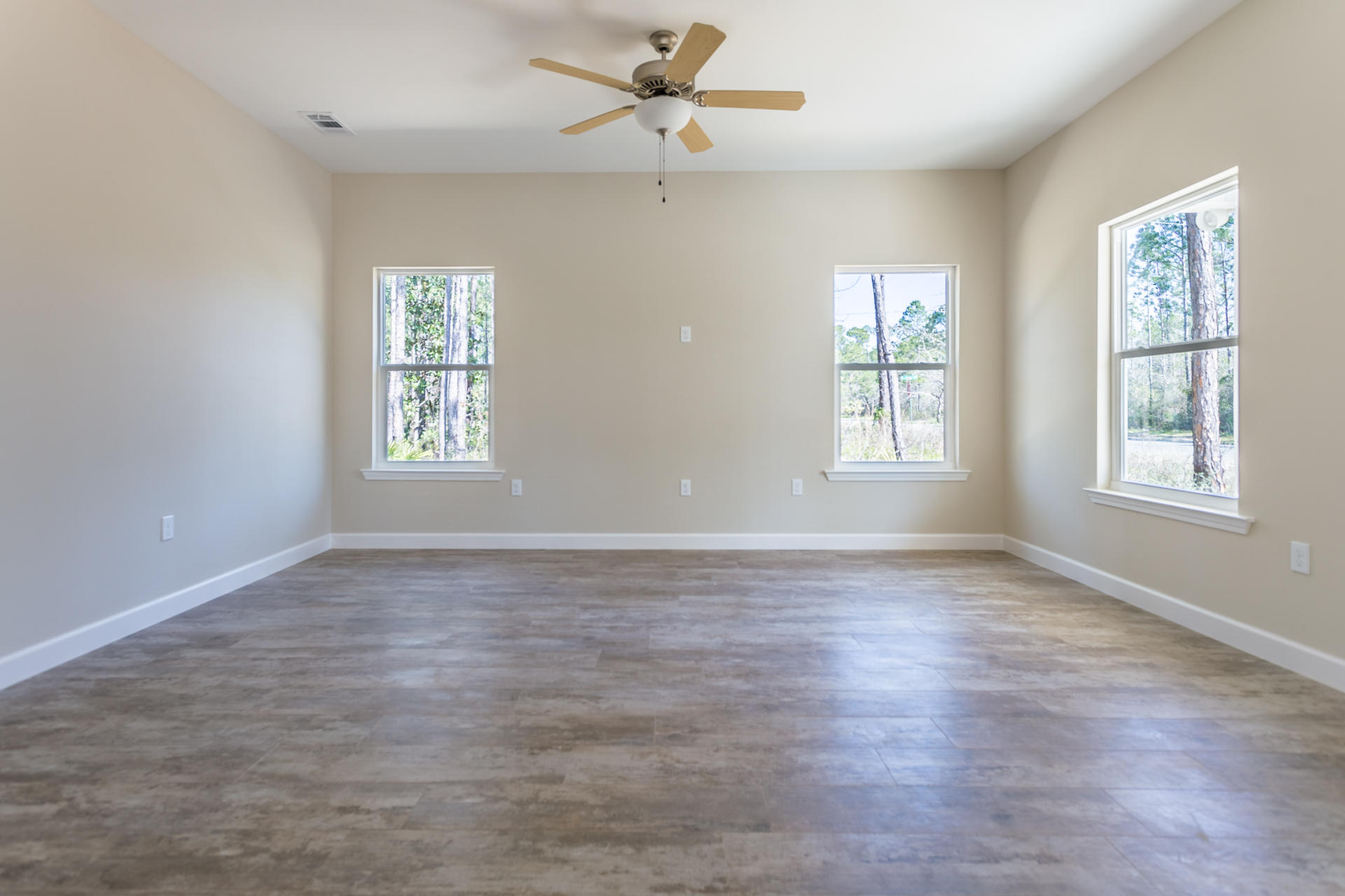 343 Indian Woman Road Santa Rosa Beach, FL 32459 - Photo 4 of 21 a view of an empty room with a window and wooden floor