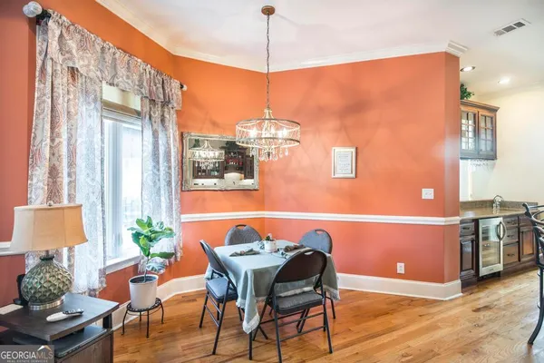 a living room with furniture kitchen view and a large window