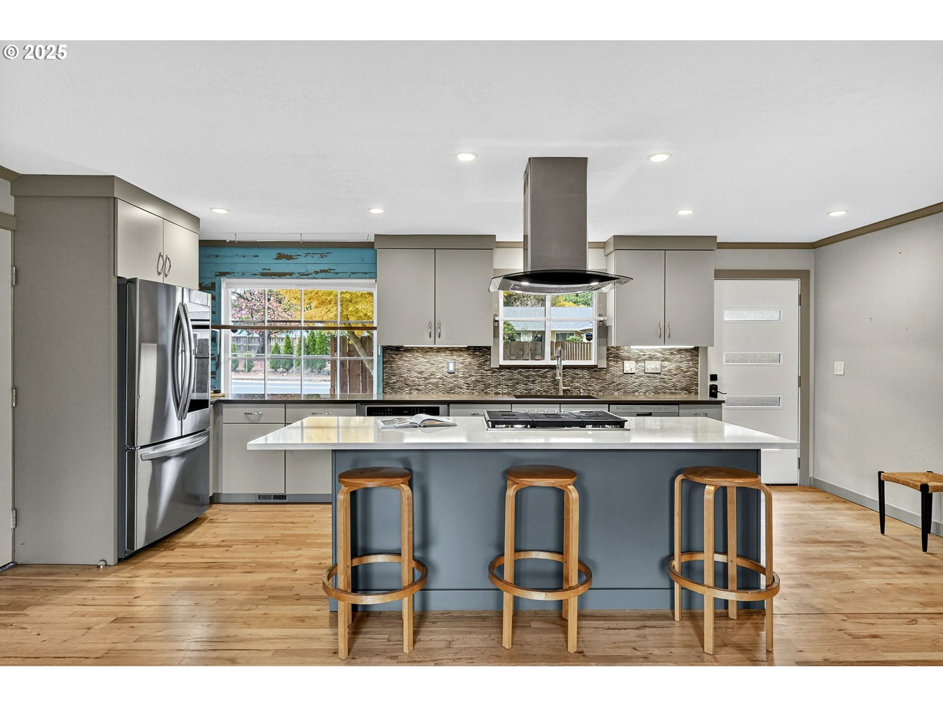 830 Northeast 172nd Avenue Portland, OR 97230 - Photo 11 of 31 a kitchen with stainless steel appliances granite countertop a table chairs refrigerator and microwave