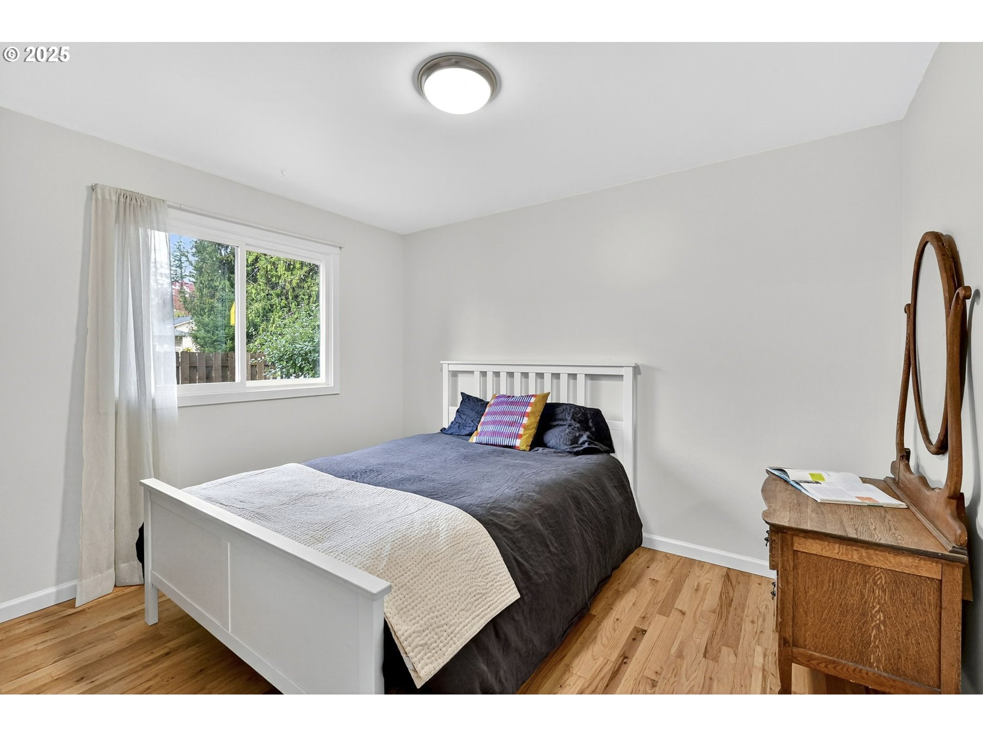 830 Northeast 172nd Avenue Portland, OR 97230 - Photo 19 of 31 a bedroom with a bed window and a flat screen tv