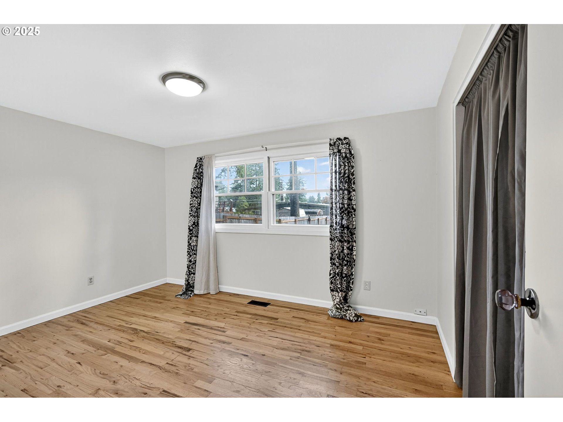 830 Northeast 172nd Avenue Portland, OR 97230 - Photo 21 of 31 a view of an empty room with window and wooden floor