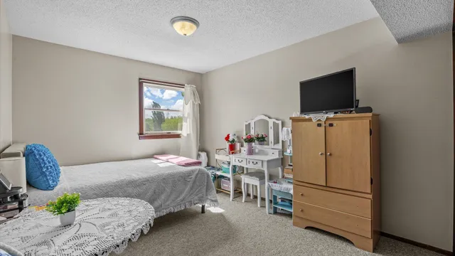 a bedroom with two bed and a chandelier