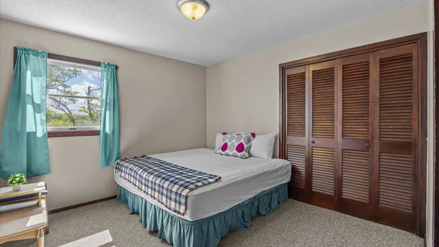 a bedroom with a bed and a window