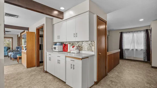 a kitchen with kitchen island cabinets and refrigerator