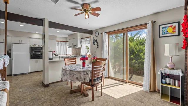 a view of kitchen with furniture and refrigerator