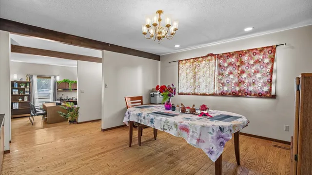 a dining room with furniture and wooden floor