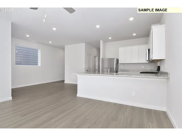 a view of kitchen with kitchen island sink stainless steel appliances and cabinets