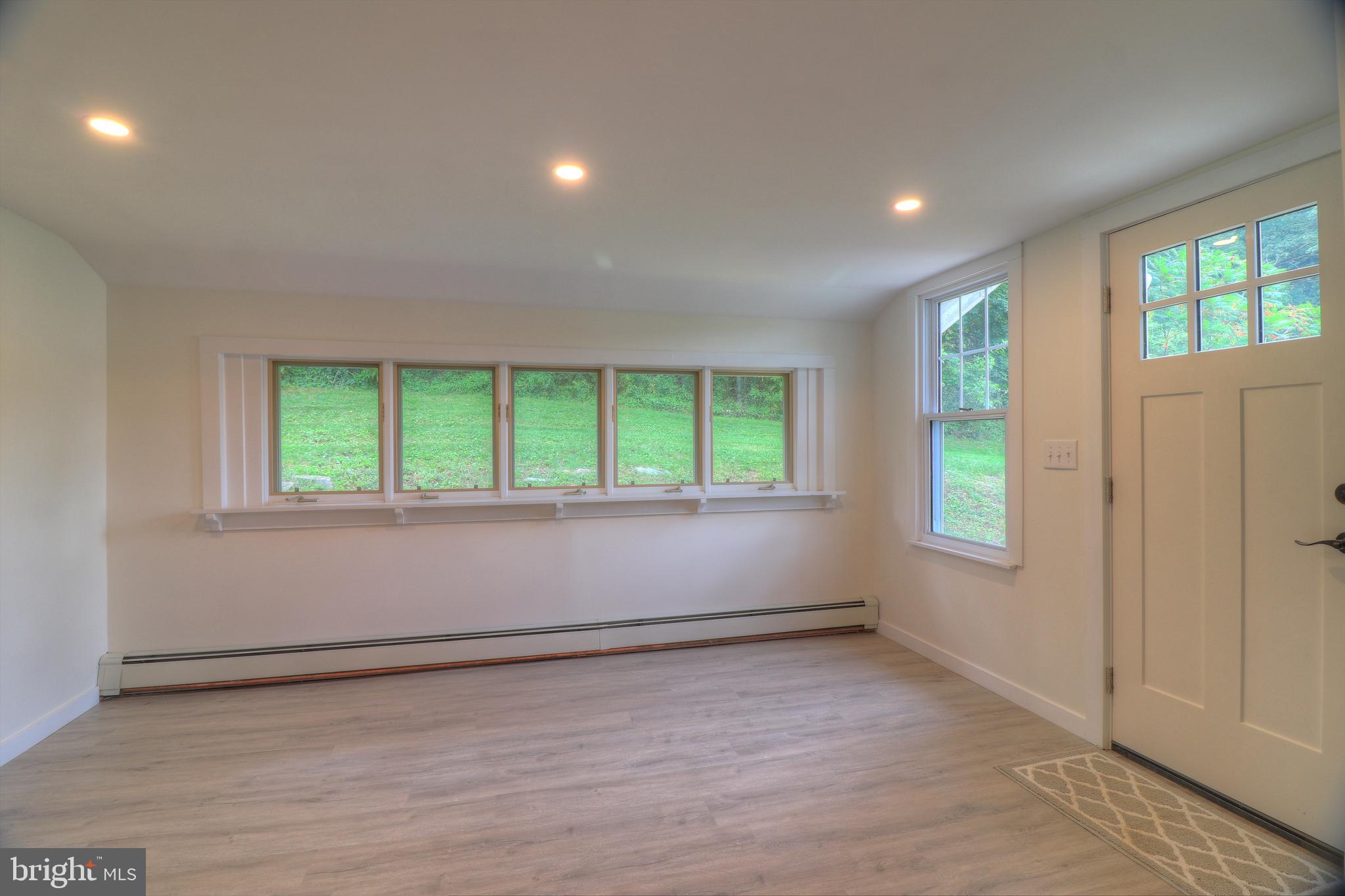 678 Rockville Road Spring Grove, PA 17362 - Photo 11 of 32 an empty room with wooden floor and windows