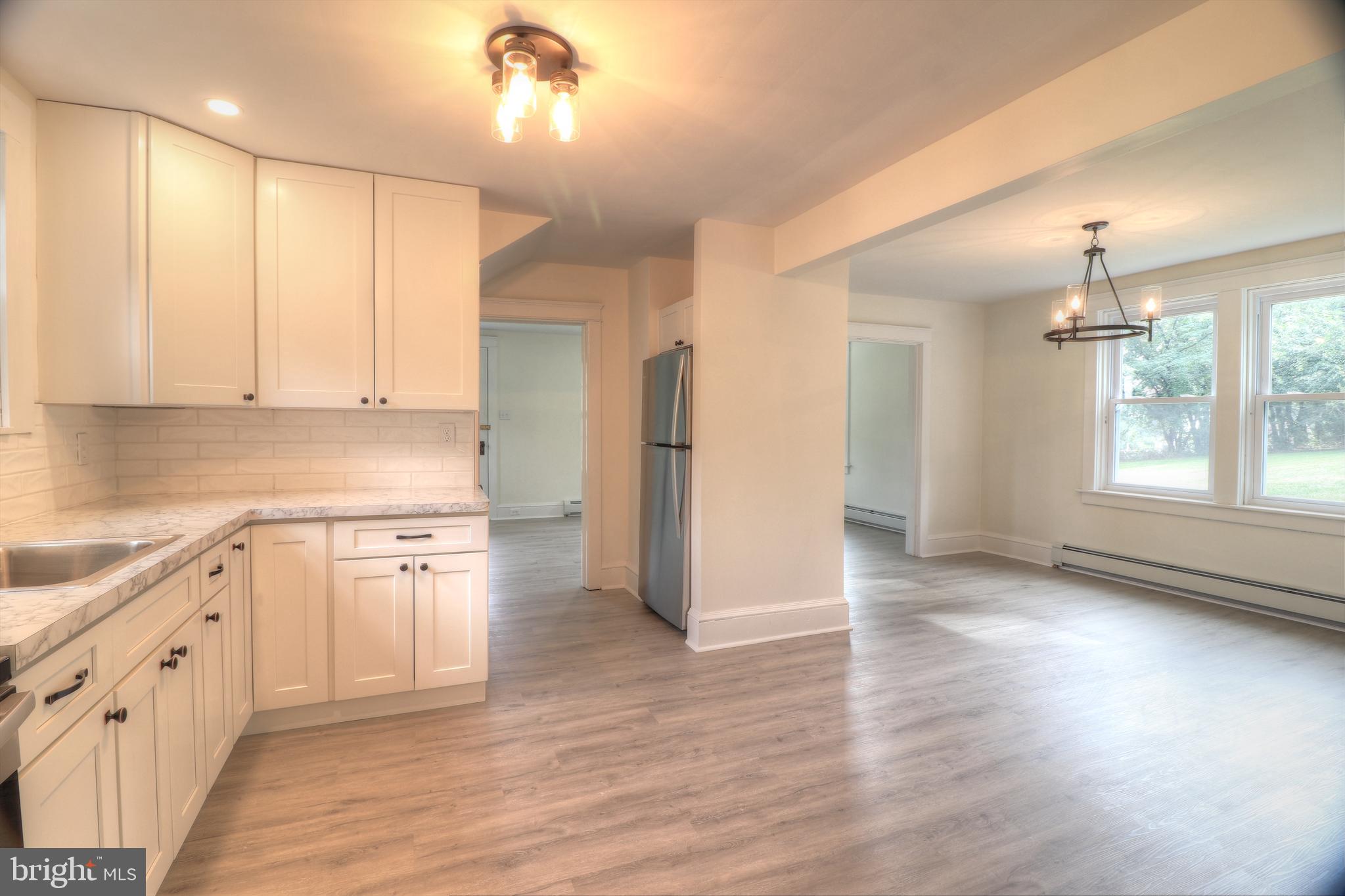 678 Rockville Road Spring Grove, PA 17362 - Photo 3 of 32 a kitchen with stainless steel appliances granite countertop a refrigerator a sink dishwasher a stove and white countertops with wooden floor