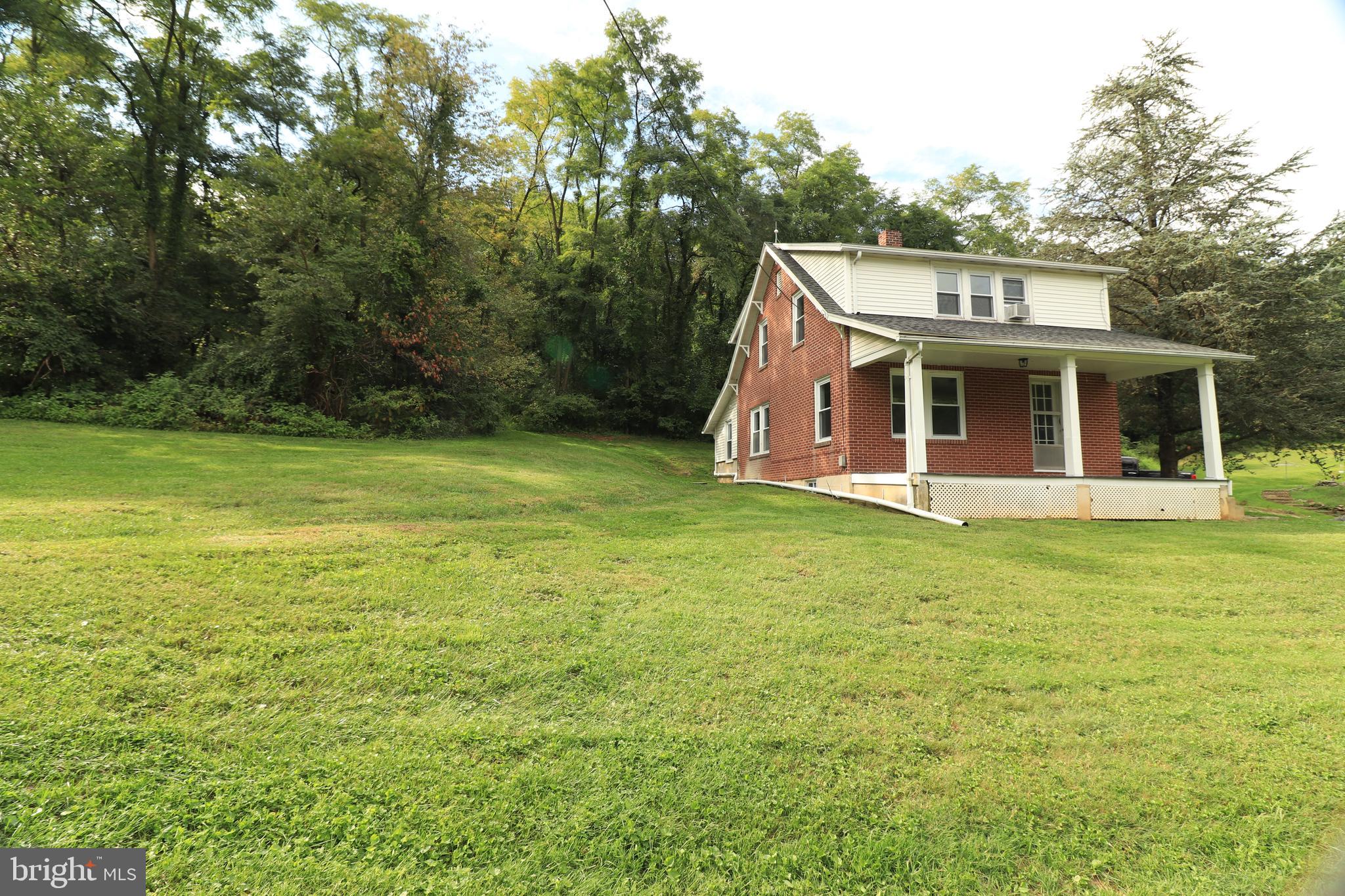 678 Rockville Road Spring Grove, PA 17362 - Photo 23 of 32 a view of a house with a yard and sitting area