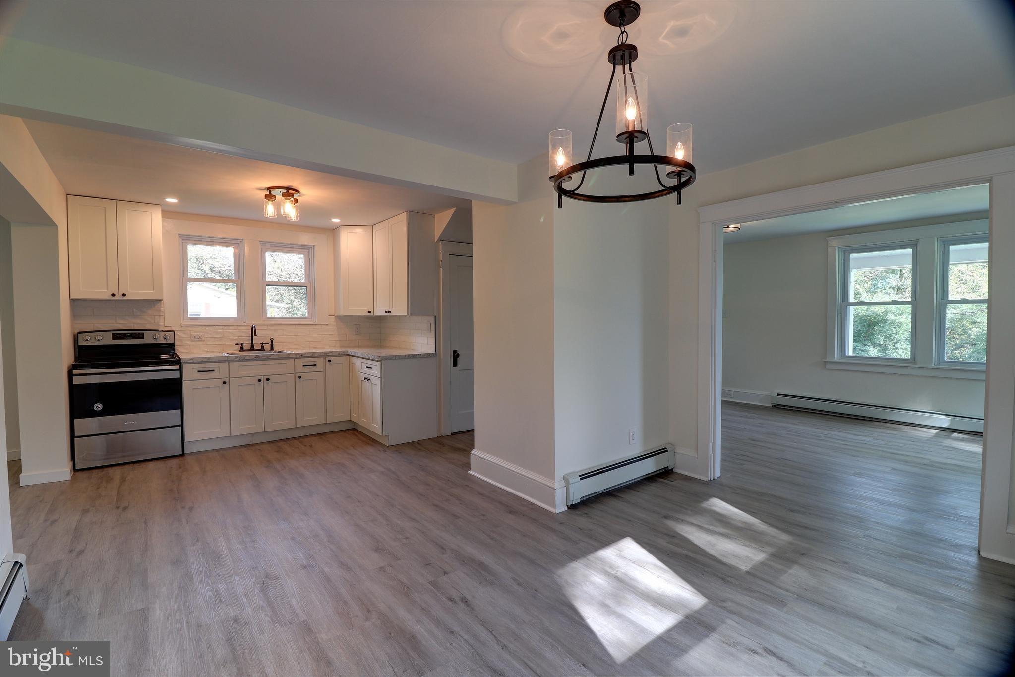 678 Rockville Road Spring Grove, PA 17362 - Photo 4 of 32 a view of a kitchen with a sink wooden floor and a window