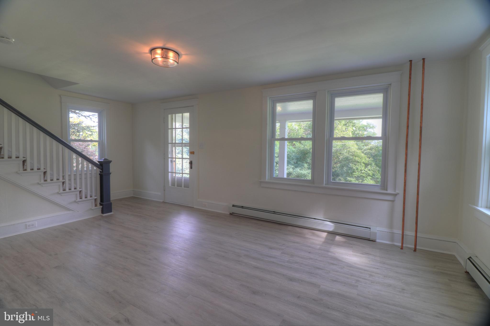 678 Rockville Road Spring Grove, PA 17362 - Photo 7 of 32 an empty room with wooden floor and windows