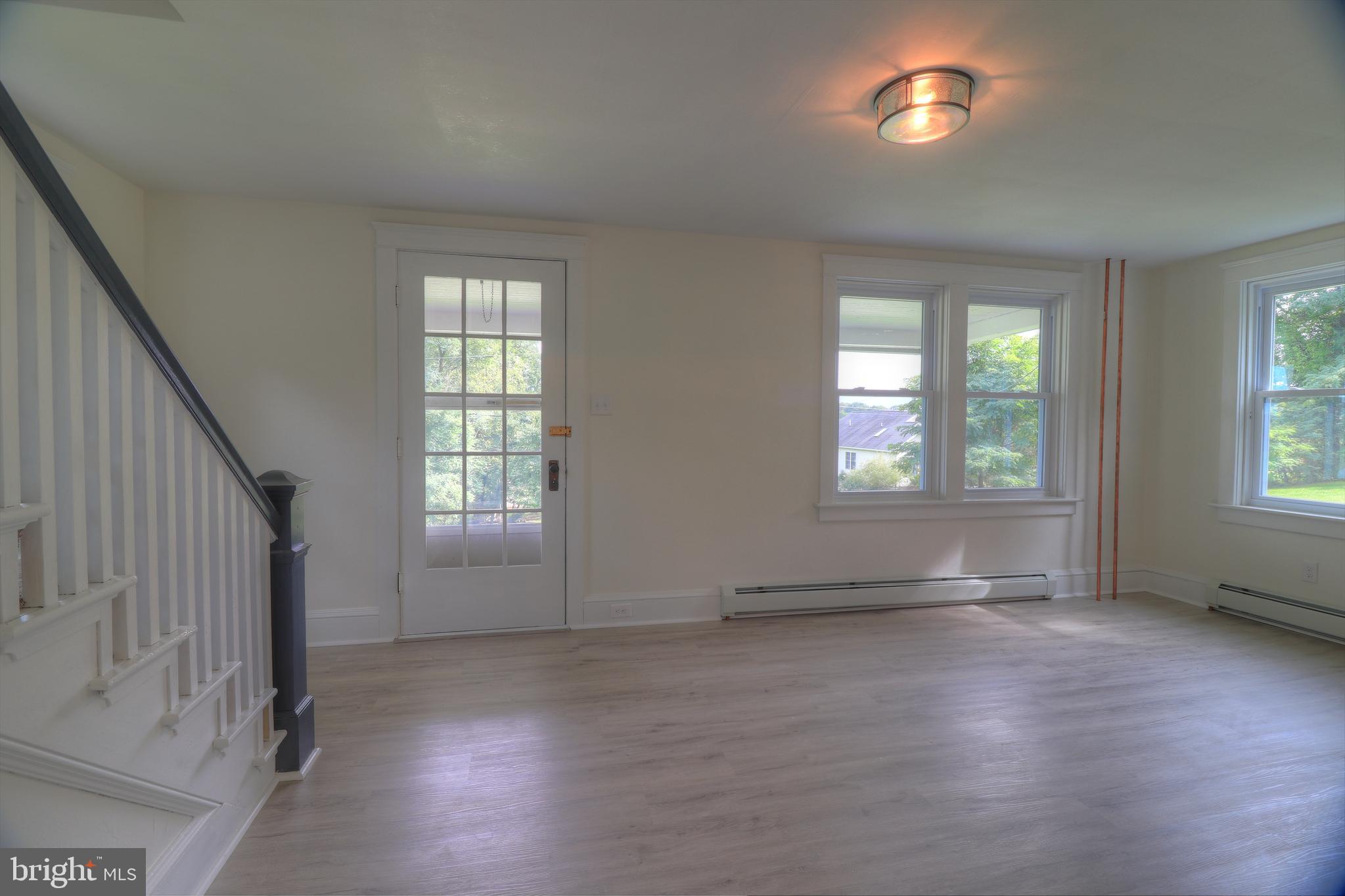 678 Rockville Road Spring Grove, PA 17362 - Photo 8 of 32 an empty room with wooden floor and windows