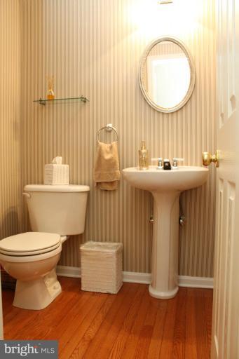 2438 Rippling Brook Road Frederick, MD 21701 - Photo 22 of 24 a bathroom with a toilet sink and mirror