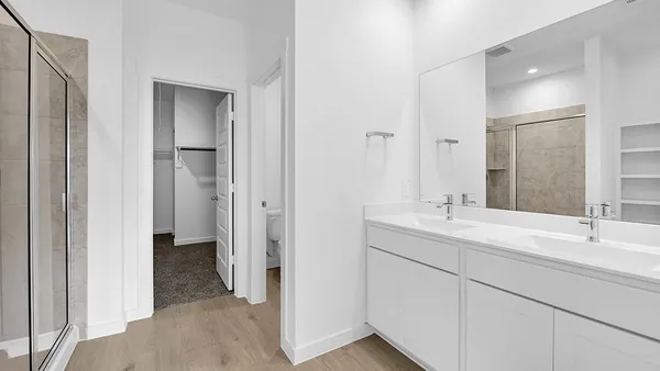 a bathroom with a glass shower door