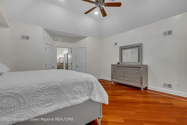 a spacious bathroom with a tub sink and mirror