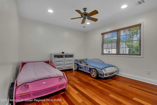 a view of a patio with couches table and chairs under an umbrella with a fire pit