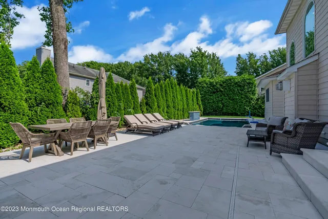 a view of a patio with a table and chairs under an umbrella