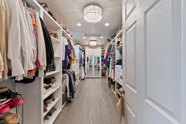 a bedroom with a bed and a chandelier