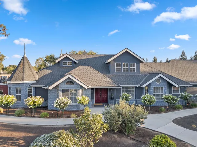 a front view of a house with a yard and street view