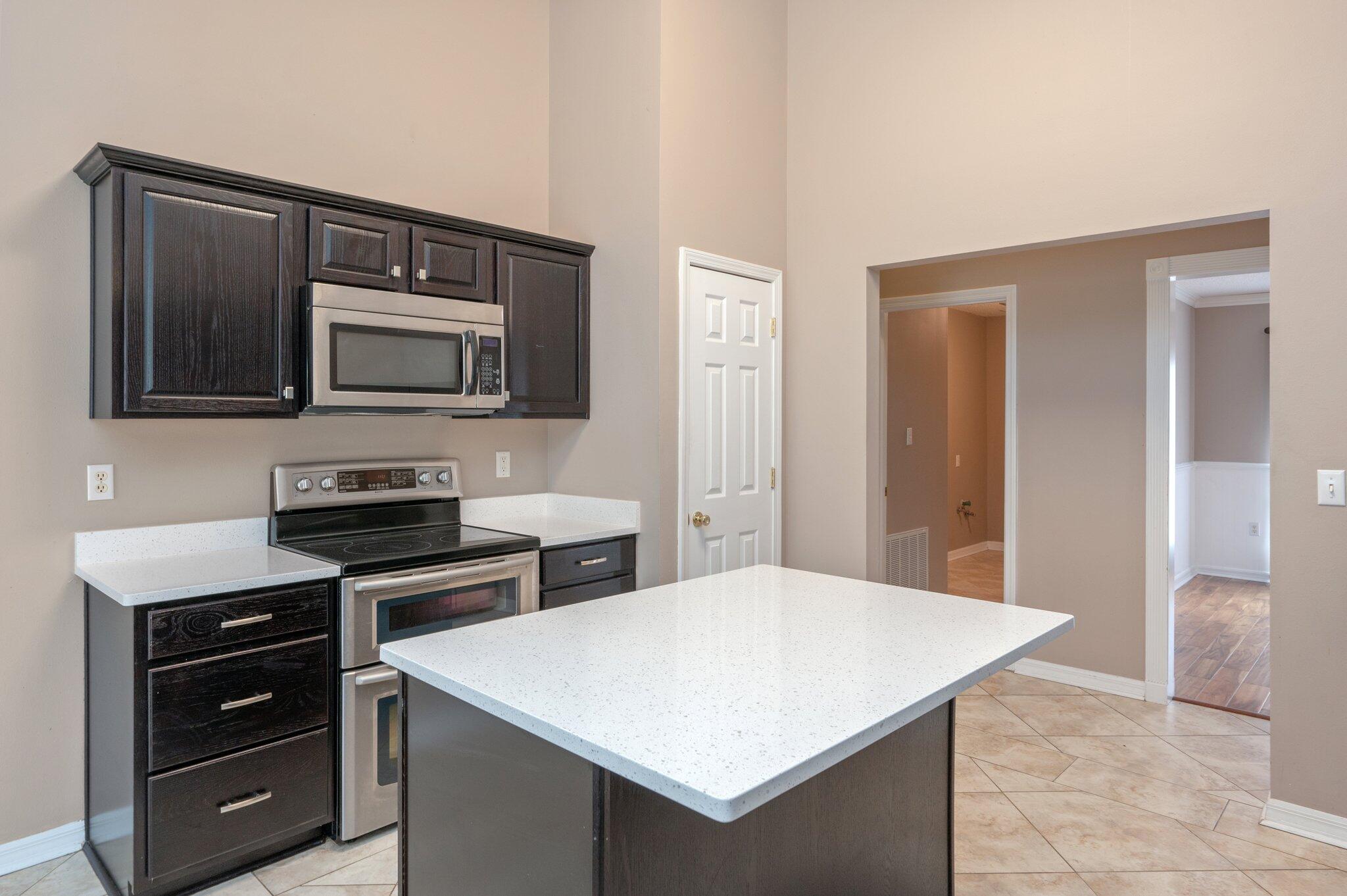 4752 Balboa Road Crestview, FL 32539 - Photo 12 of 46 a kitchen with stainless steel appliances a stove microwave and refrigerator
