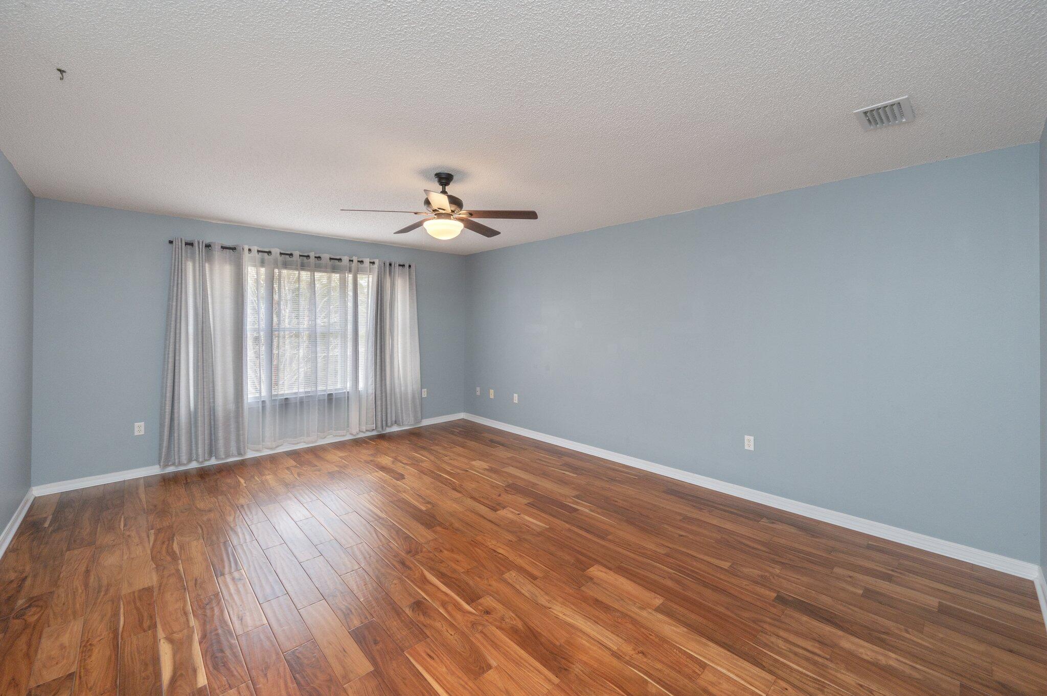 4752 Balboa Road Crestview, FL 32539 - Photo 20 of 46 a view of an empty room with wooden floor and a window