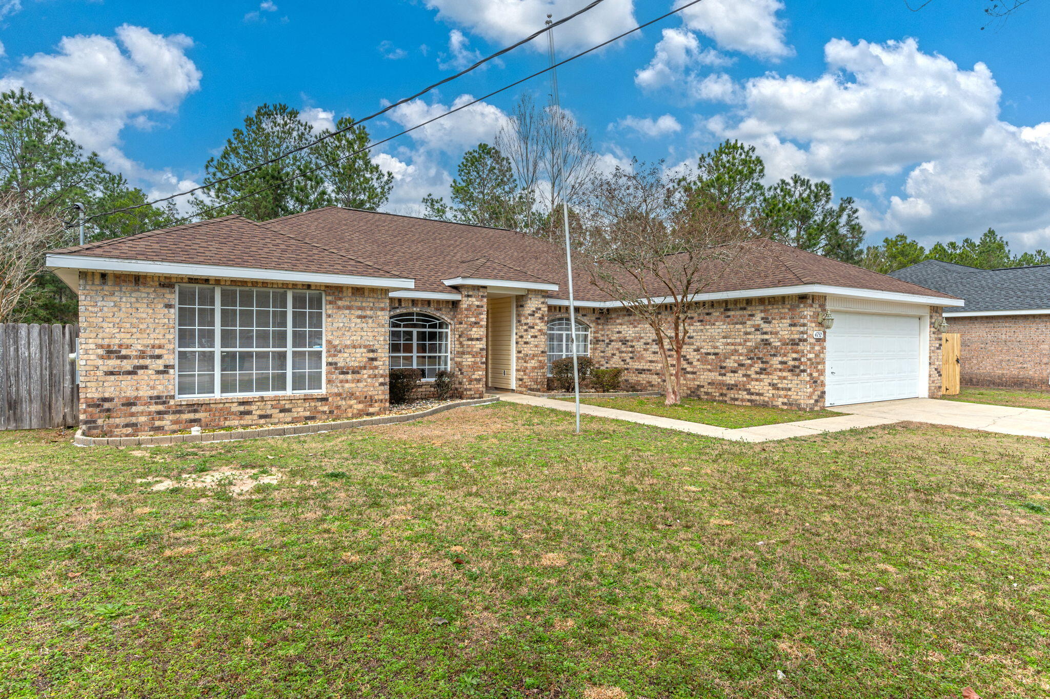 4752 Balboa Road Crestview, FL 32539 - Photo 2 of 46 a view of a backyard with a garden and tree