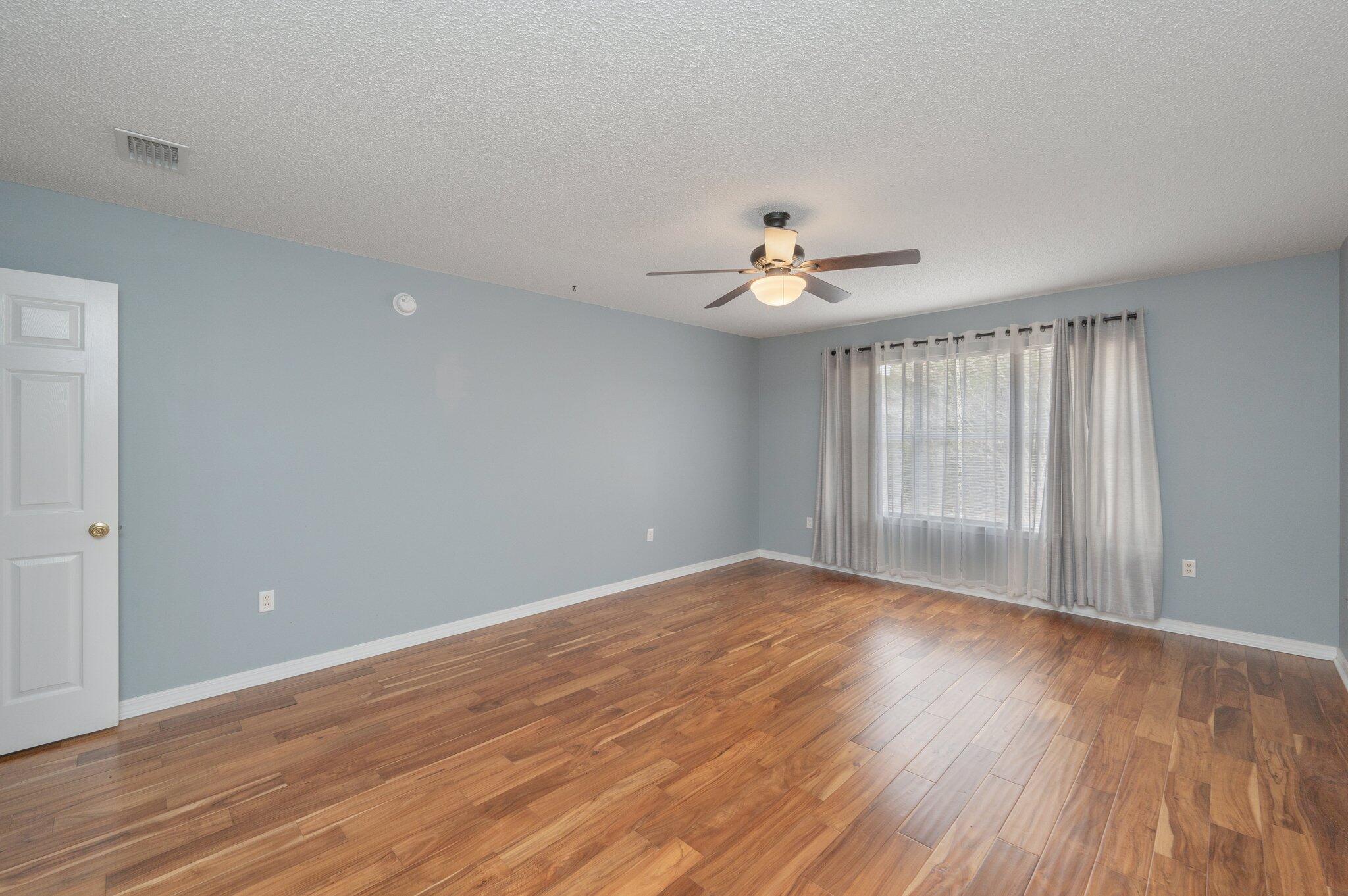 4752 Balboa Road Crestview, FL 32539 - Photo 23 of 46 a view of an empty room with wooden floor and a window
