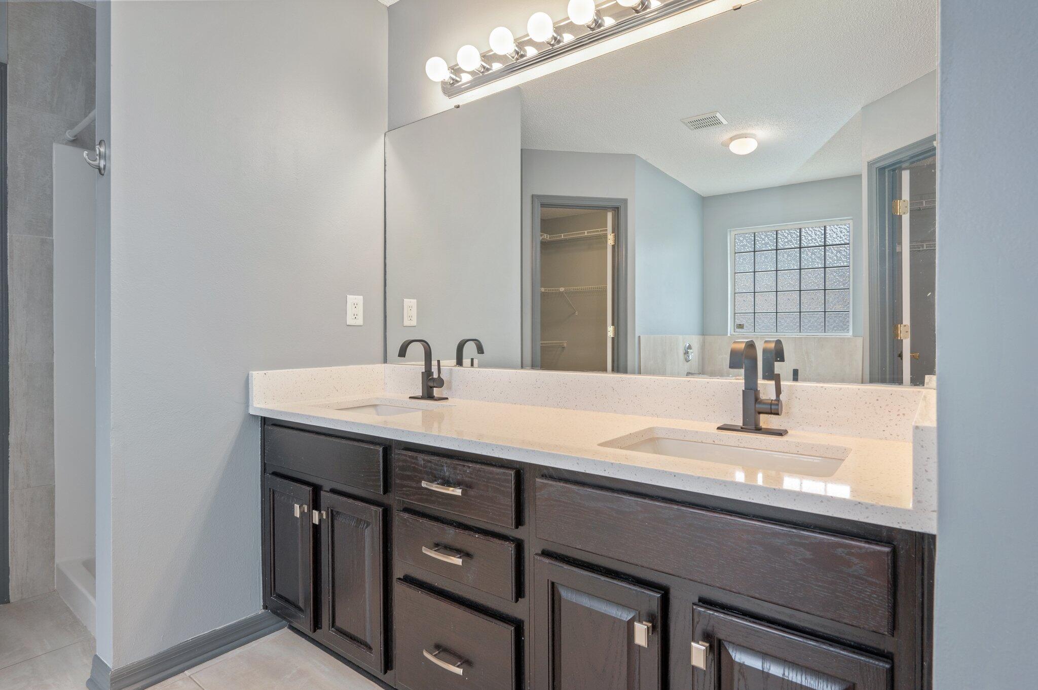 4752 Balboa Road Crestview, FL 32539 - Photo 24 of 46 a bathroom with a sink double vanity and a mirror