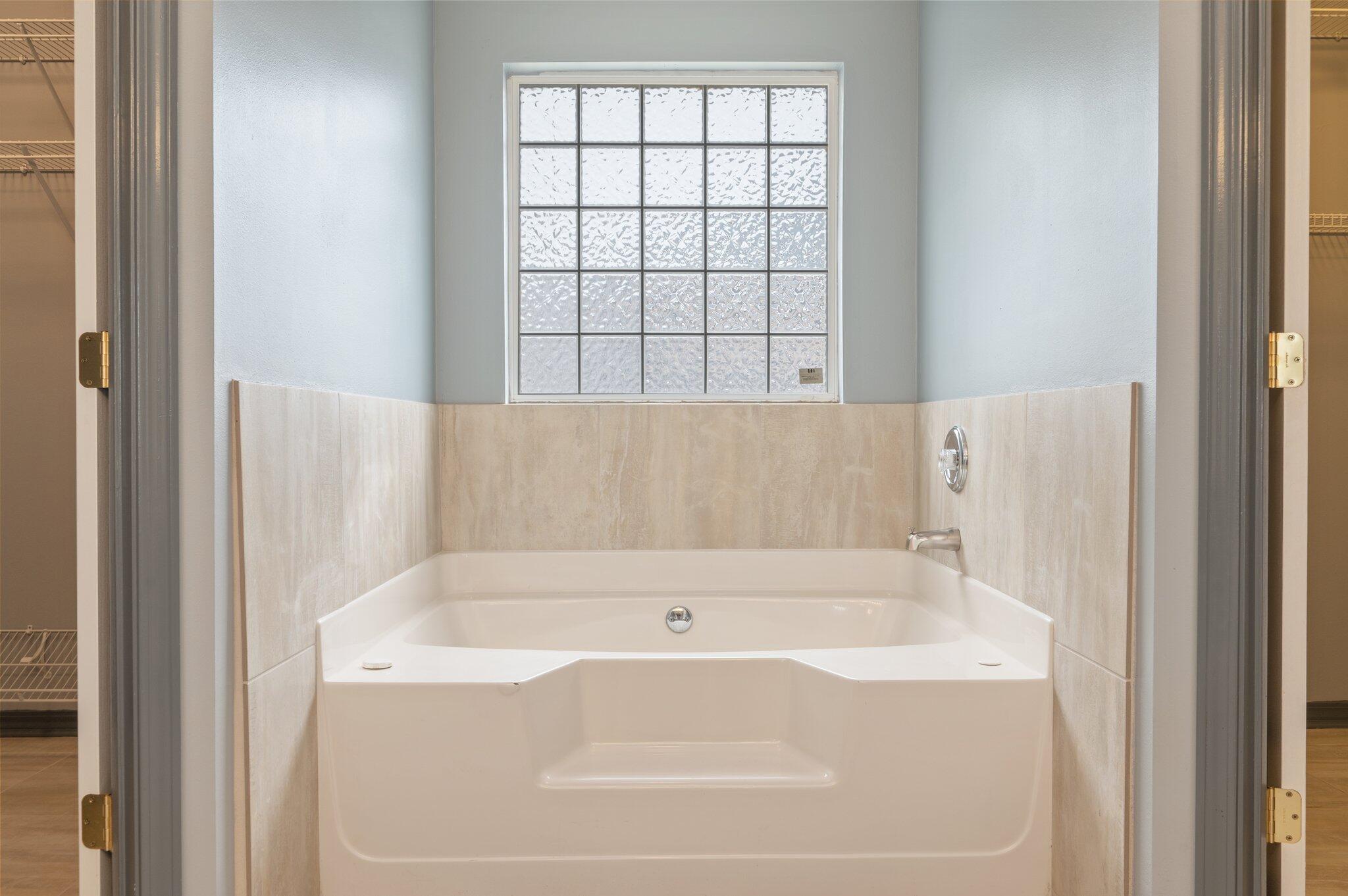 4752 Balboa Road Crestview, FL 32539 - Photo 26 of 46 a bathroom with bathtub and window