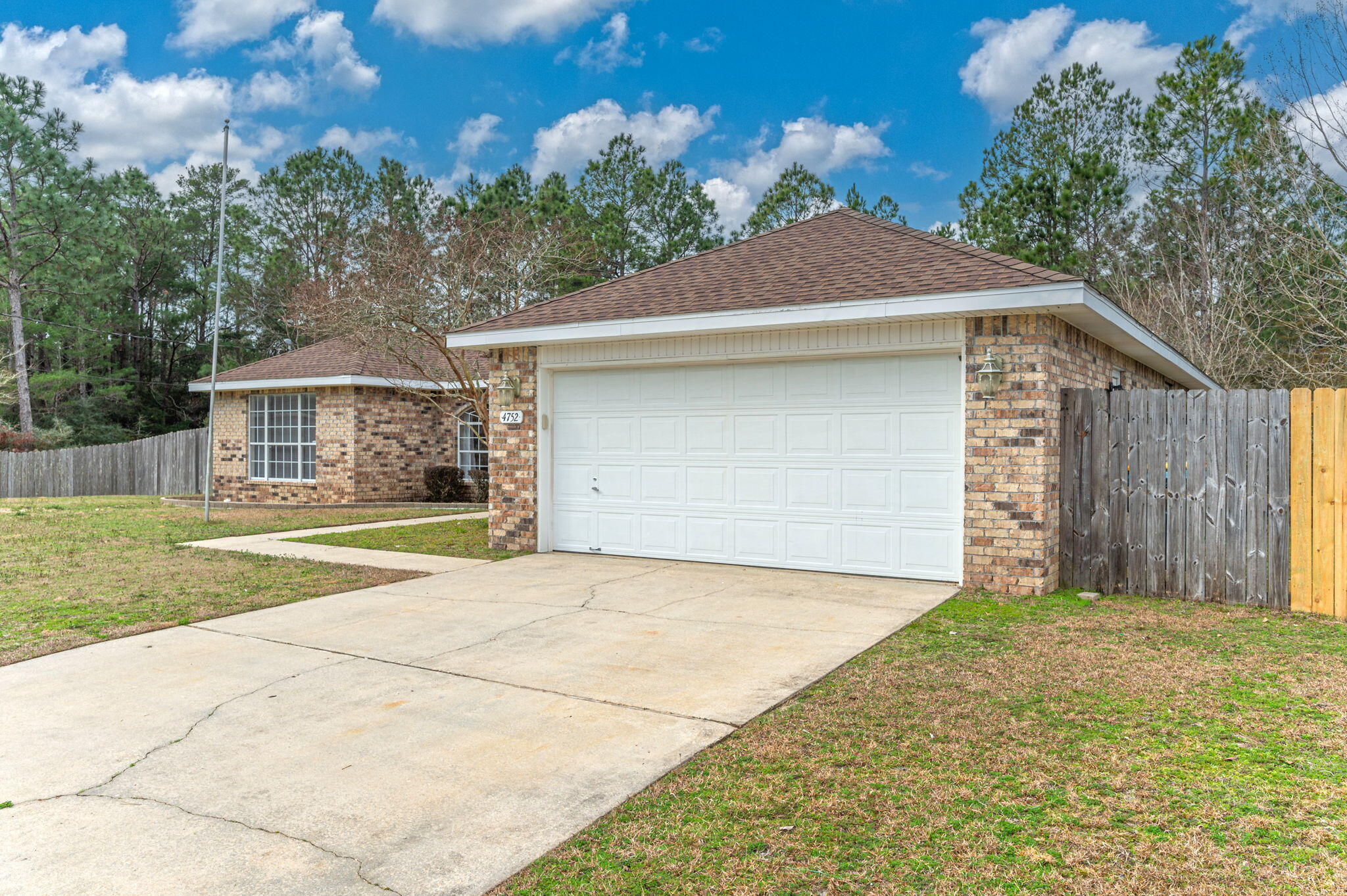 4752 Balboa Road Crestview, FL 32539 - Photo 3 of 46 a front view of a house with a yard and garage