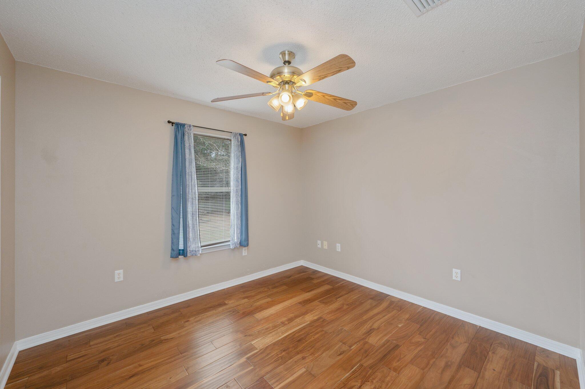 4752 Balboa Road Crestview, FL 32539 - Photo 31 of 46 a view of an empty room with window and wooden floor