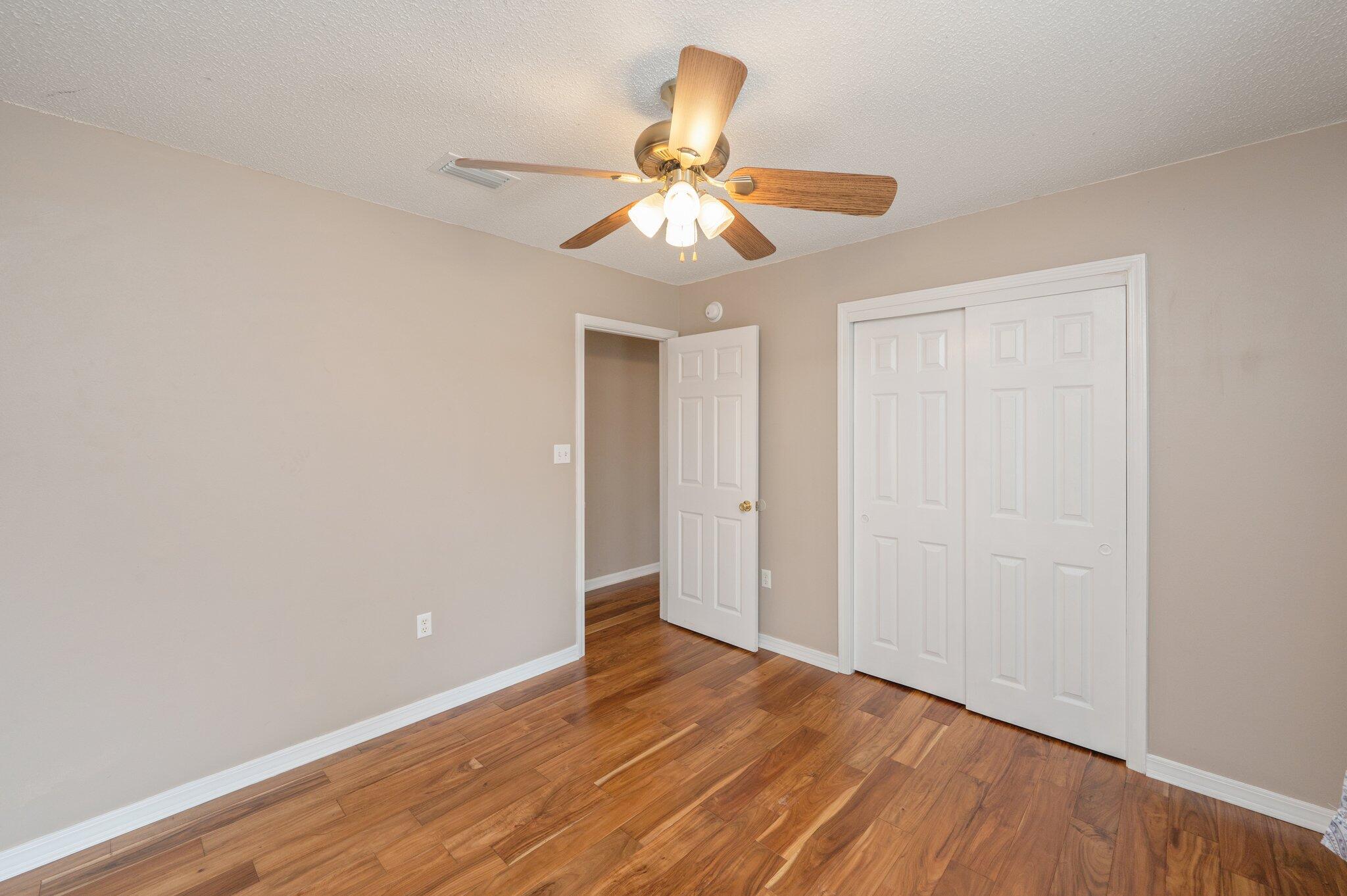 4752 Balboa Road Crestview, FL 32539 - Photo 32 of 46 a view of an empty room with window and wooden floor