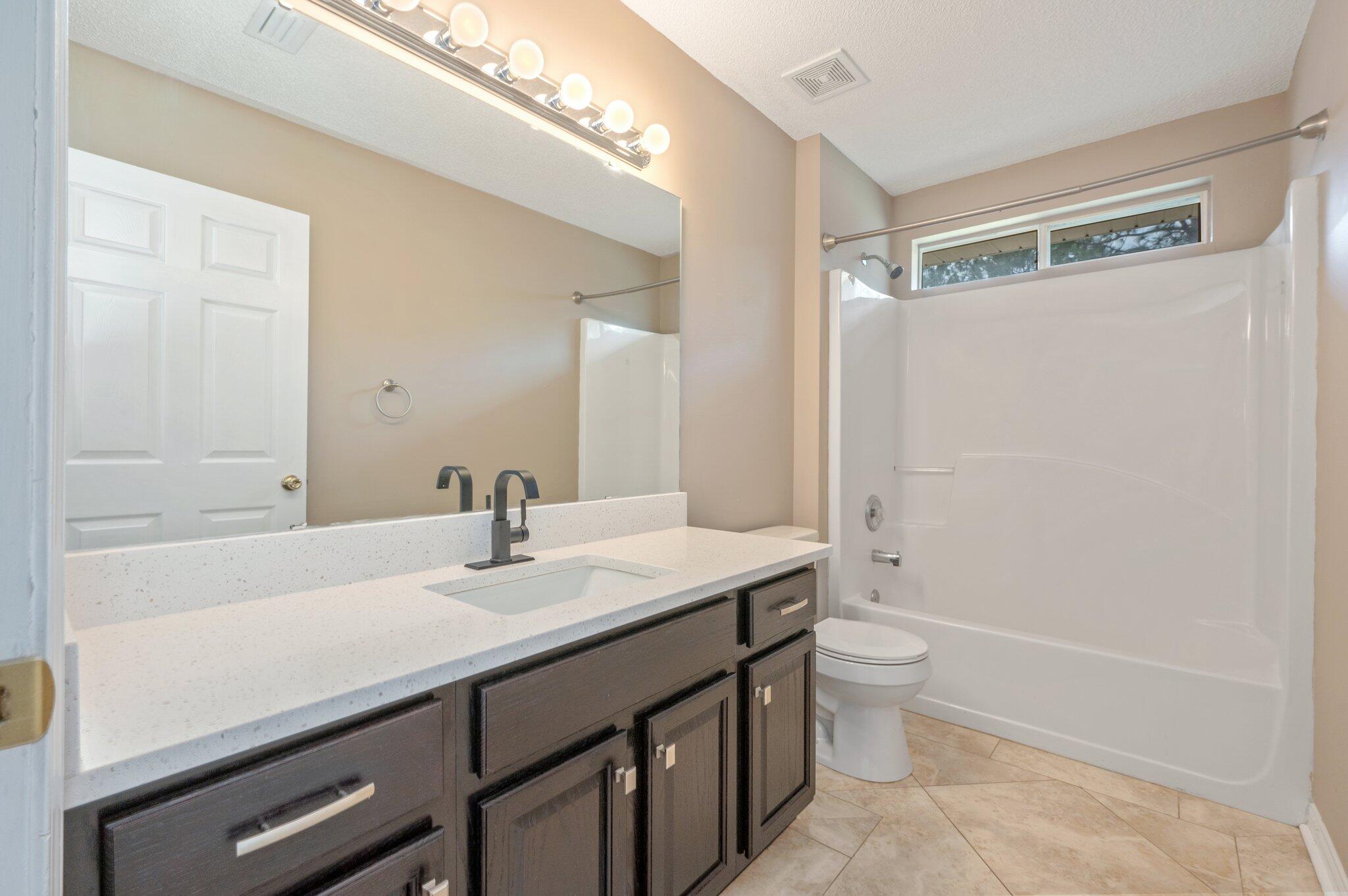 4752 Balboa Road Crestview, FL 32539 - Photo 35 of 46 a bathroom with a sink a toilet and shower
