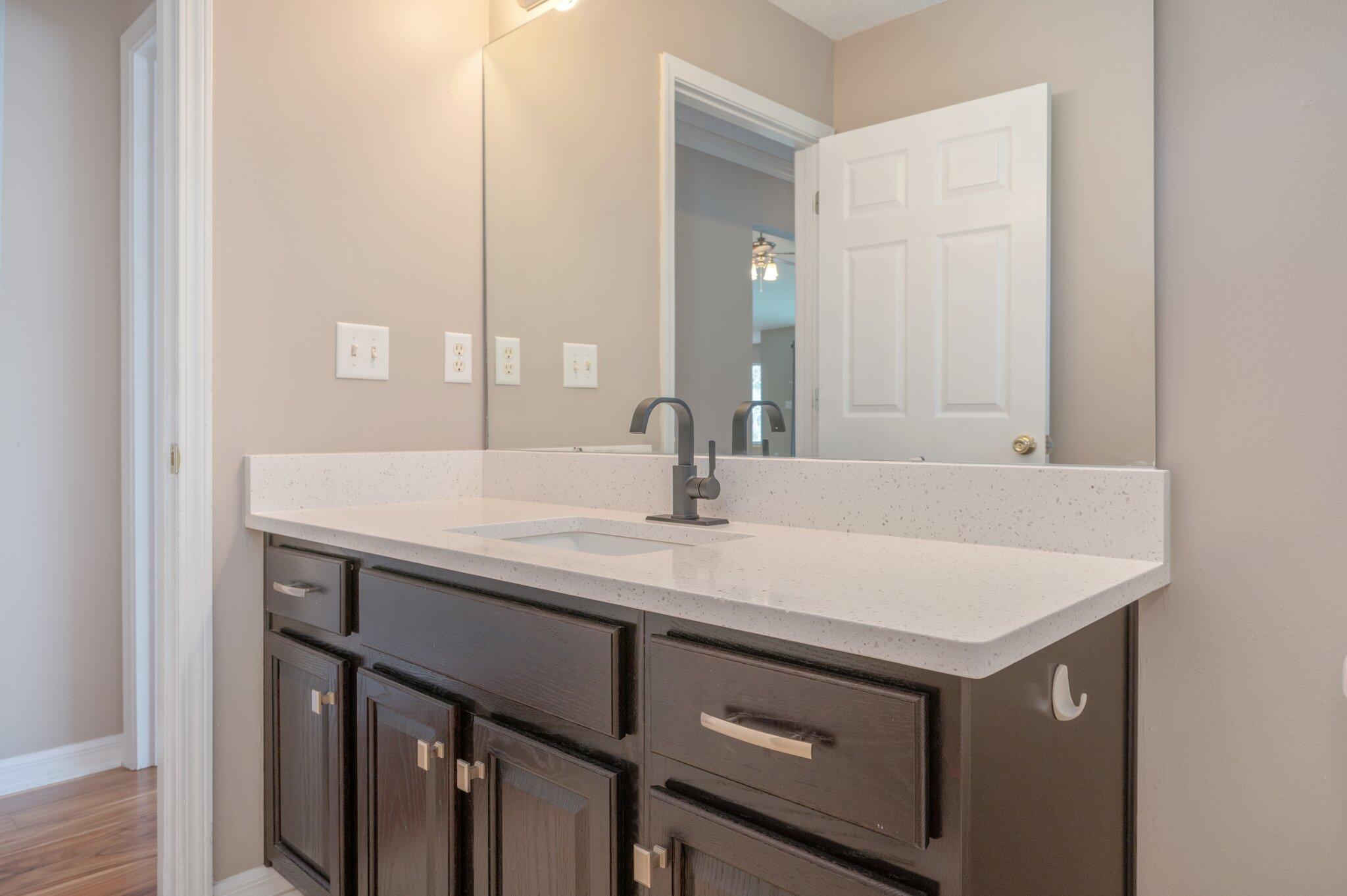 4752 Balboa Road Crestview, FL 32539 - Photo 37 of 46 a bathroom with a sink and a mirror