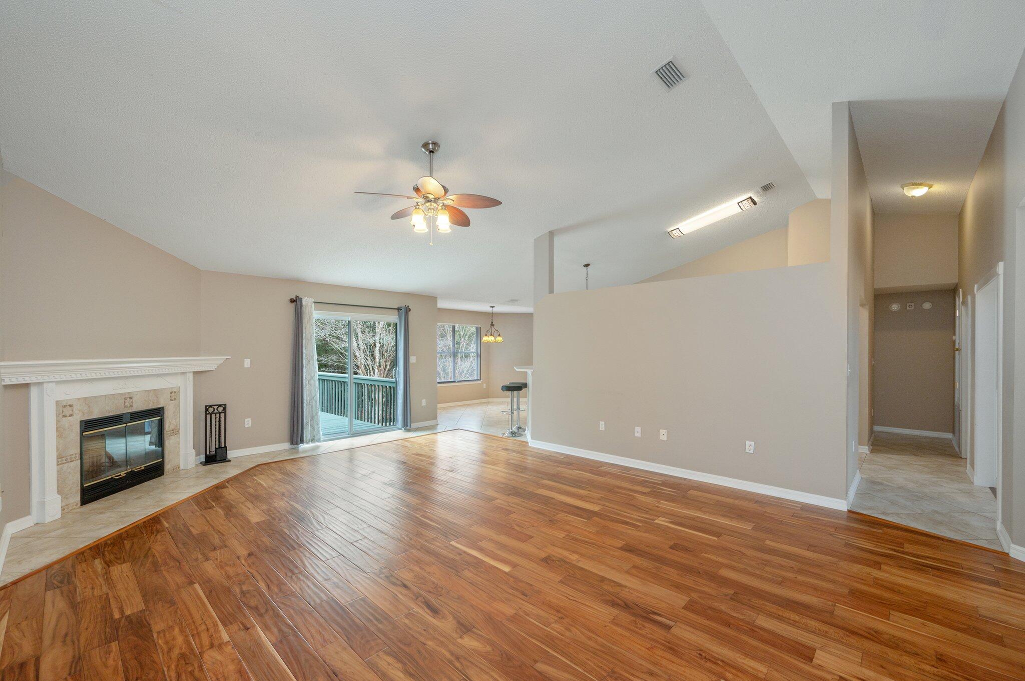 4752 Balboa Road Crestview, FL 32539 - Photo 7 of 46 wooden floor in an empty room with a fireplace
