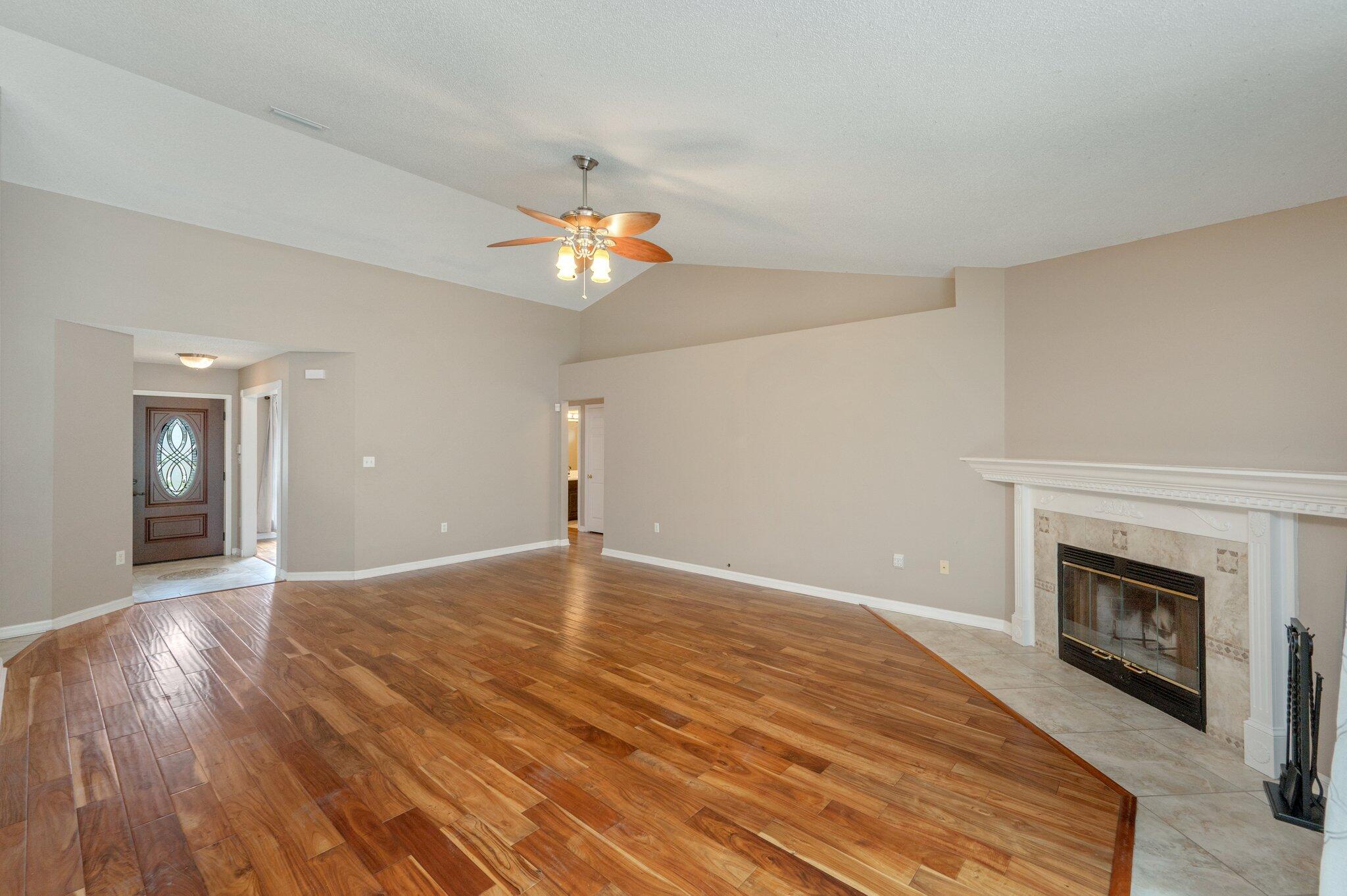 4752 Balboa Road Crestview, FL 32539 - Photo 8 of 46 a view of empty room with wooden floor and fireplace