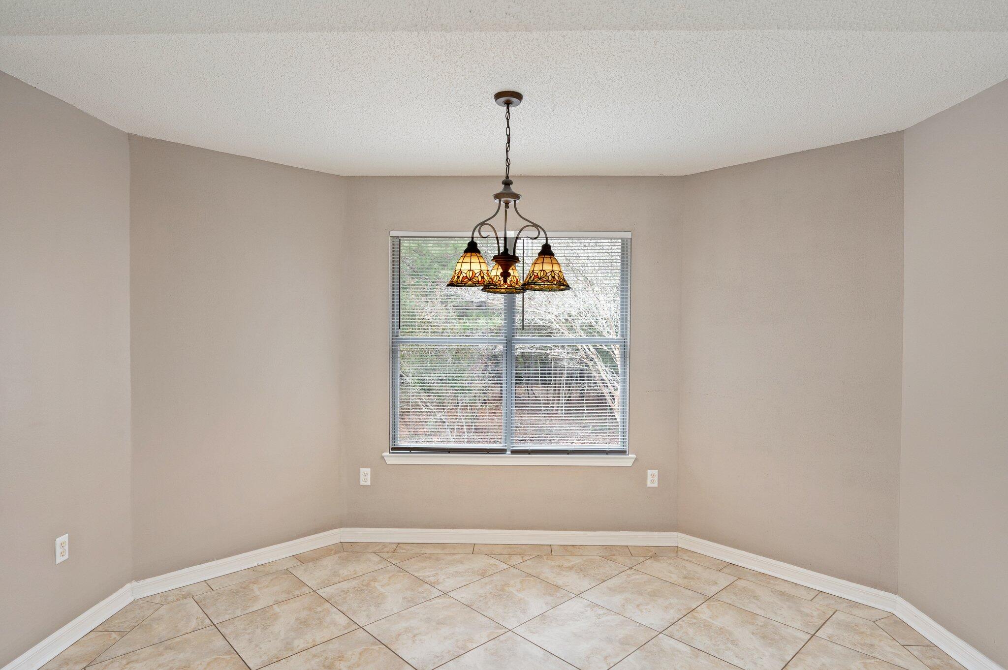 4752 Balboa Road Crestview, FL 32539 - Photo 9 of 46 a room with window and a chandelier