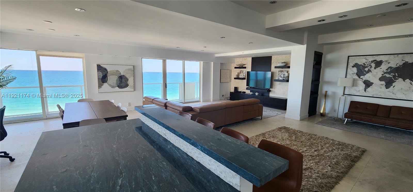 9499 Collins Avenue, Unit PH02 Surfside, FL 33154 - Photo 11 of 19 a living room with furniture and a rug