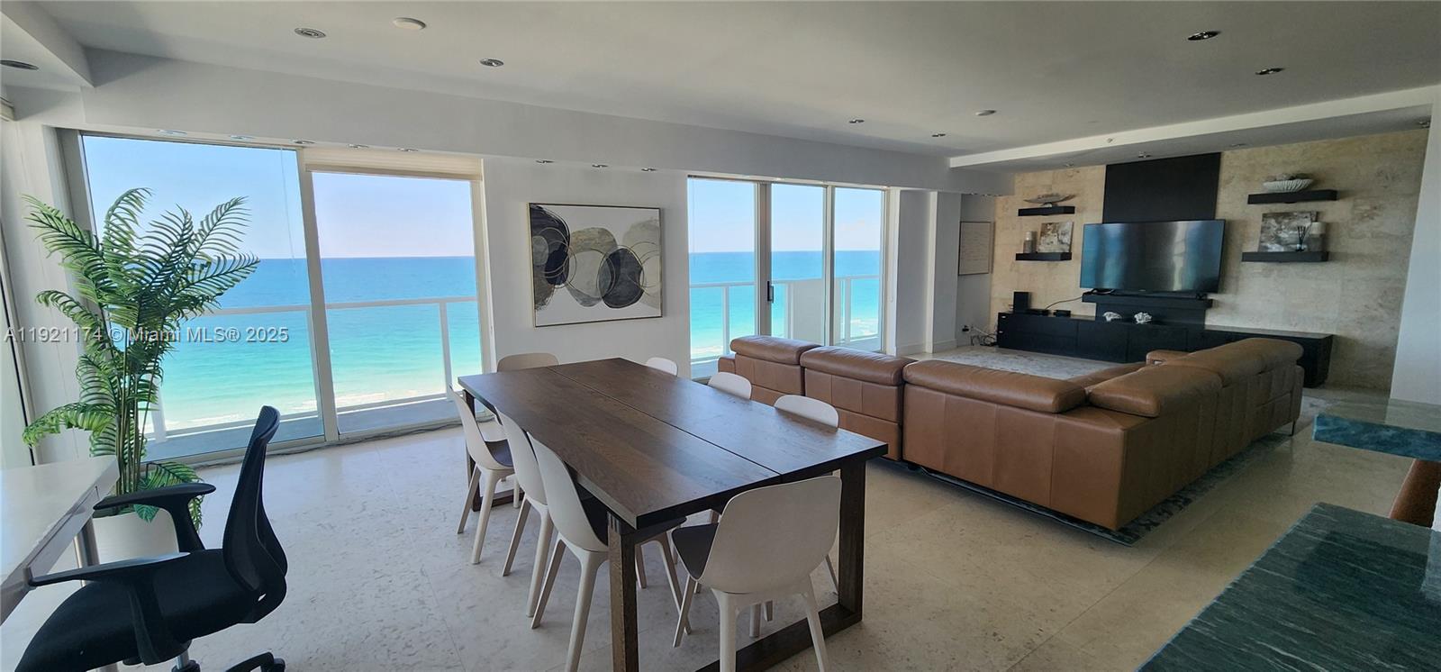 9499 Collins Avenue, Unit PH02 Surfside, FL 33154 - Photo 14 of 19 a living room with furniture and a potted plant