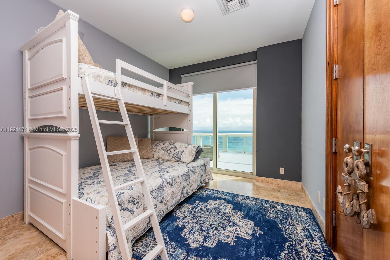 9499 Collins Avenue, Unit PH02 Surfside, FL 33154 - Photo 18 of 19 a bedroom with a bed and a window