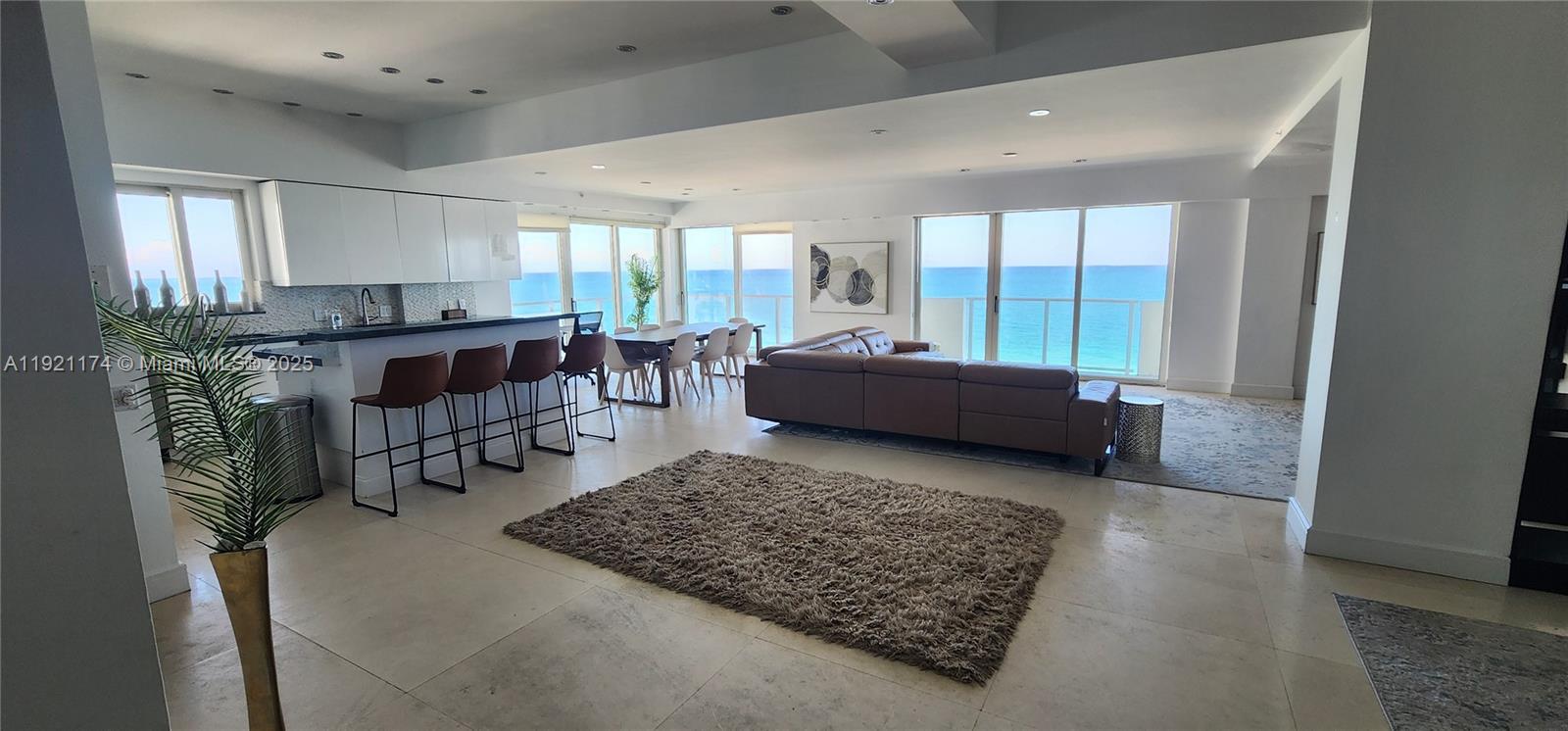 9499 Collins Avenue, Unit PH02 Surfside, FL 33154 - Photo 10 of 19 a living room with furniture rug and a table