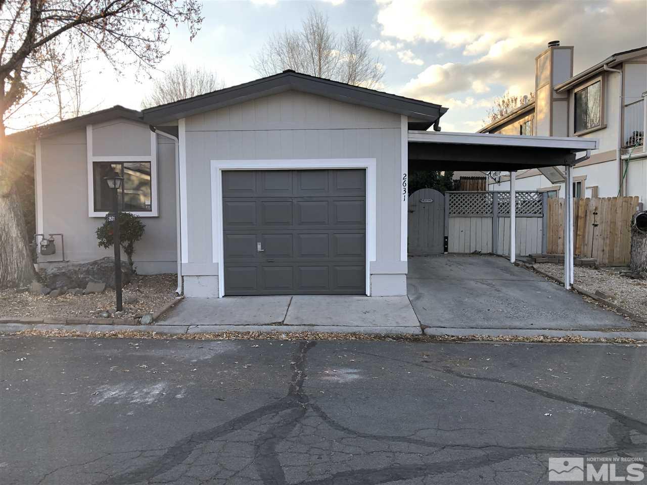 2631 Zinnia Avenue Reno, NV 89512 - Photo 1 of 15 a front view of a house with a yard and garage