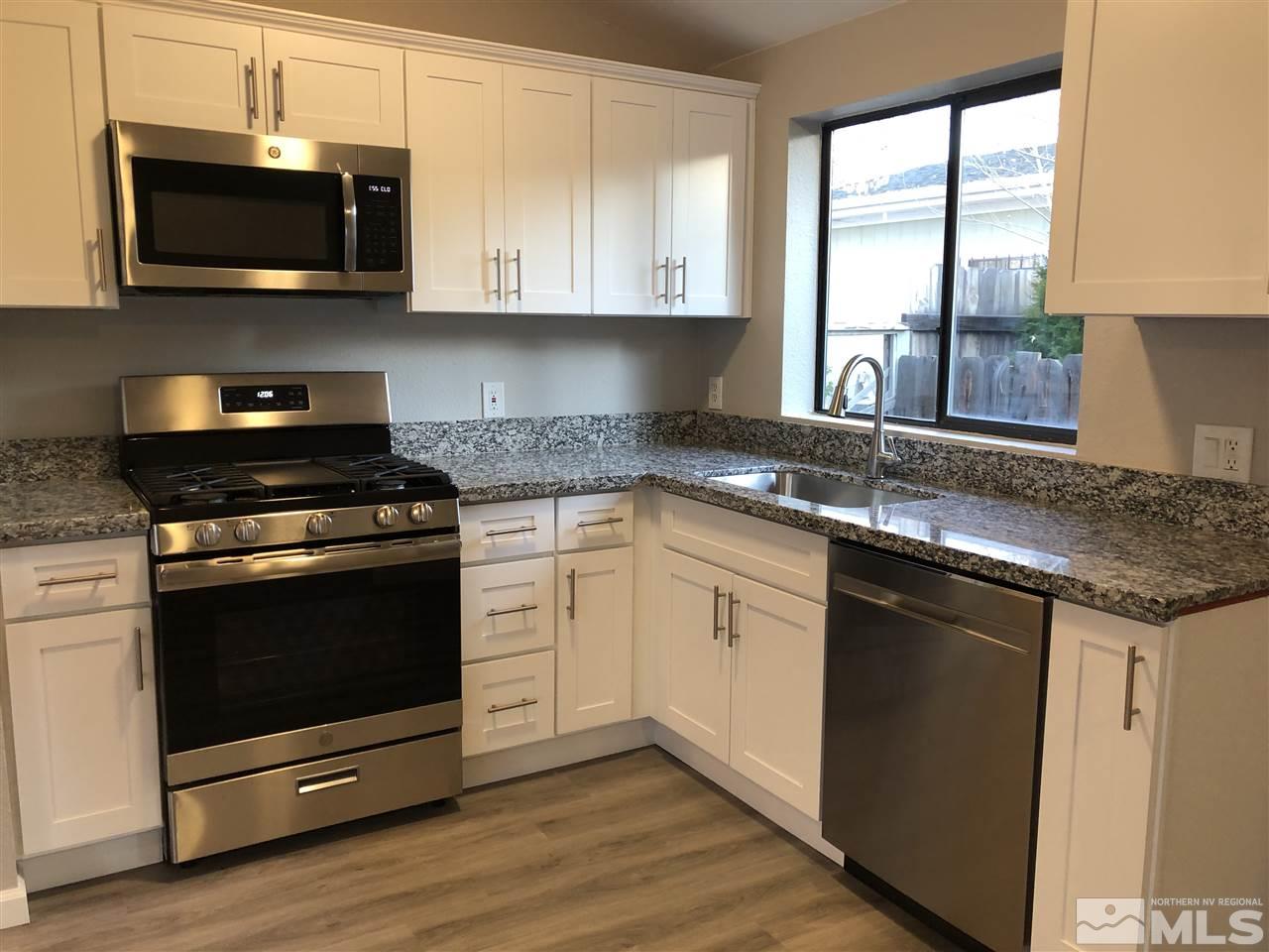 2631 Zinnia Avenue Reno, NV 89512 - Photo 7 of 15 a kitchen with granite countertop cabinets stainless steel appliances and a window