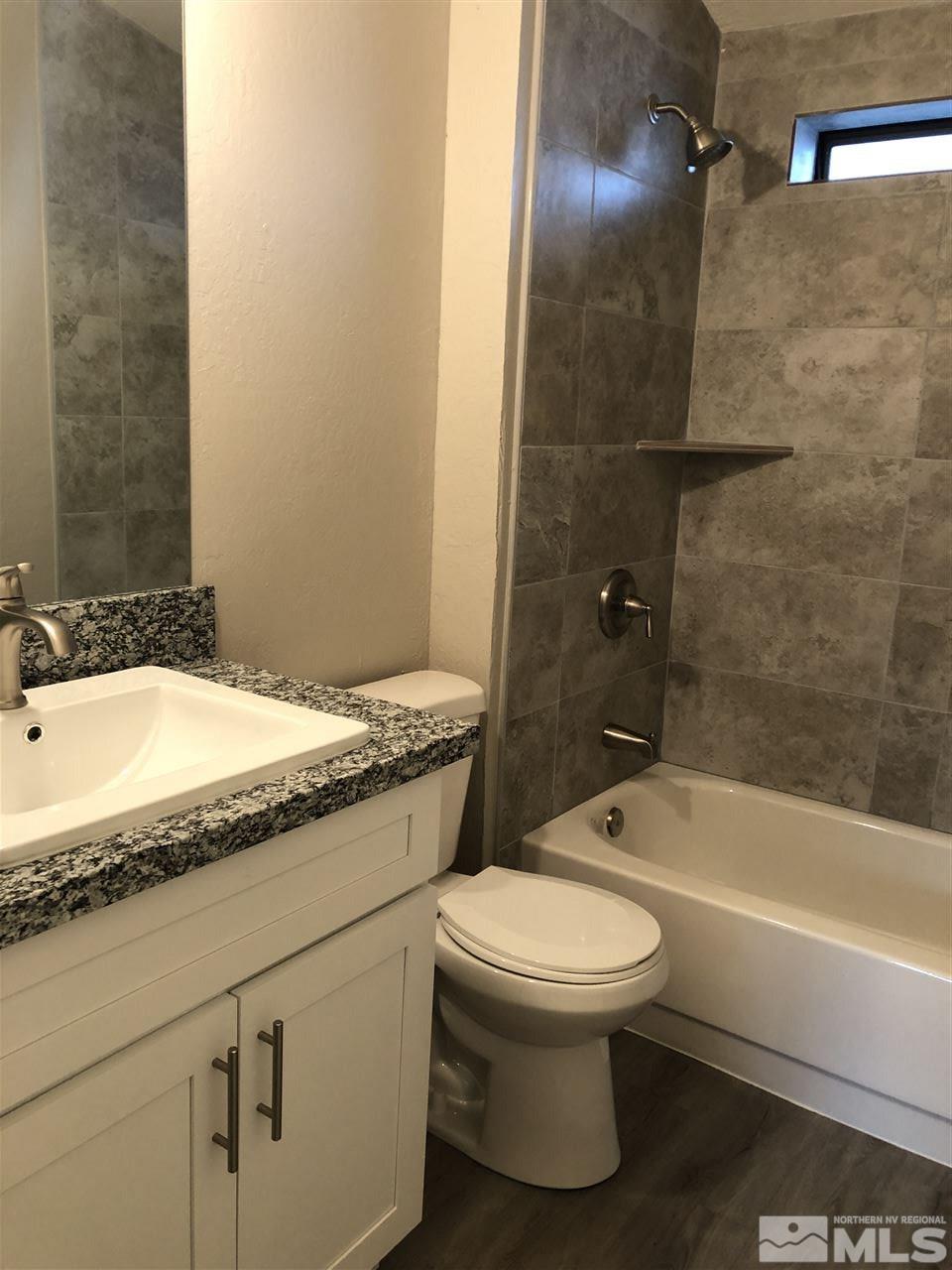 2631 Zinnia Avenue Reno, NV 89512 - Photo 8 of 15 a bathroom with a granite countertop sink toilet and shower