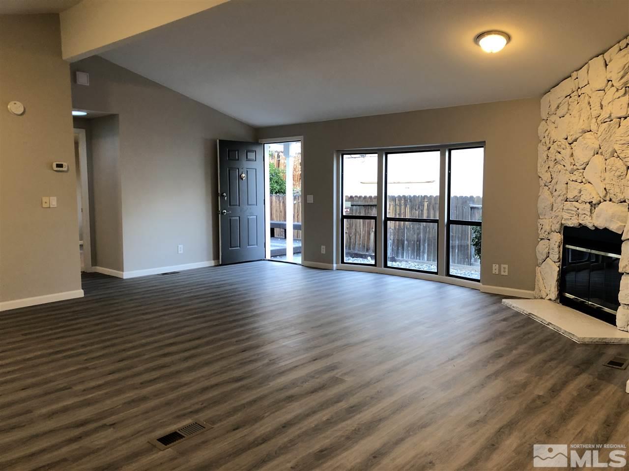 2631 Zinnia Avenue Reno, NV 89512 - Photo 9 of 15 wooden floor in an empty room with a fireplace
