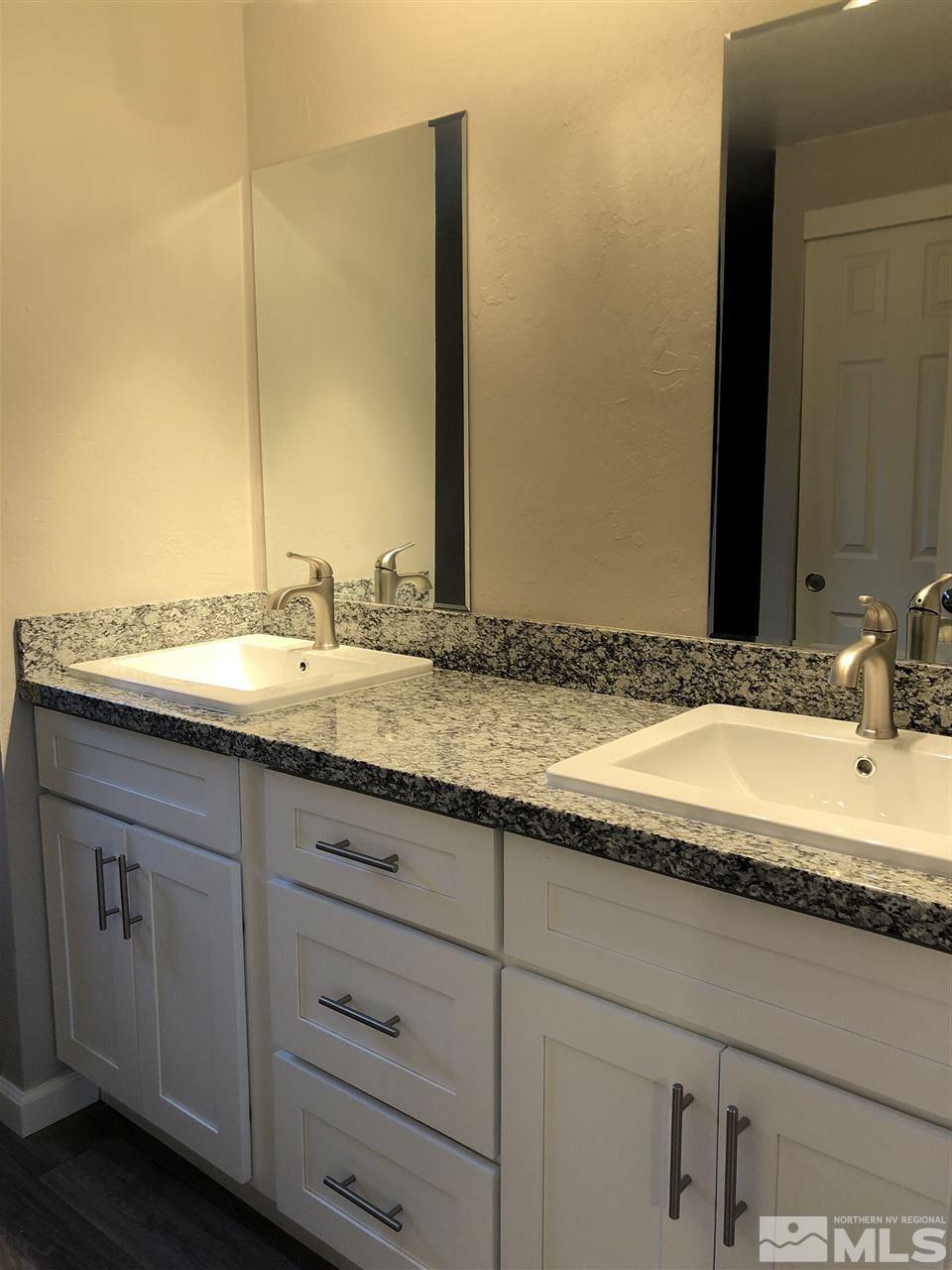 2631 Zinnia Avenue Reno, NV 89512 - Photo 10 of 15 a bathroom with a granite countertop sink and a mirror